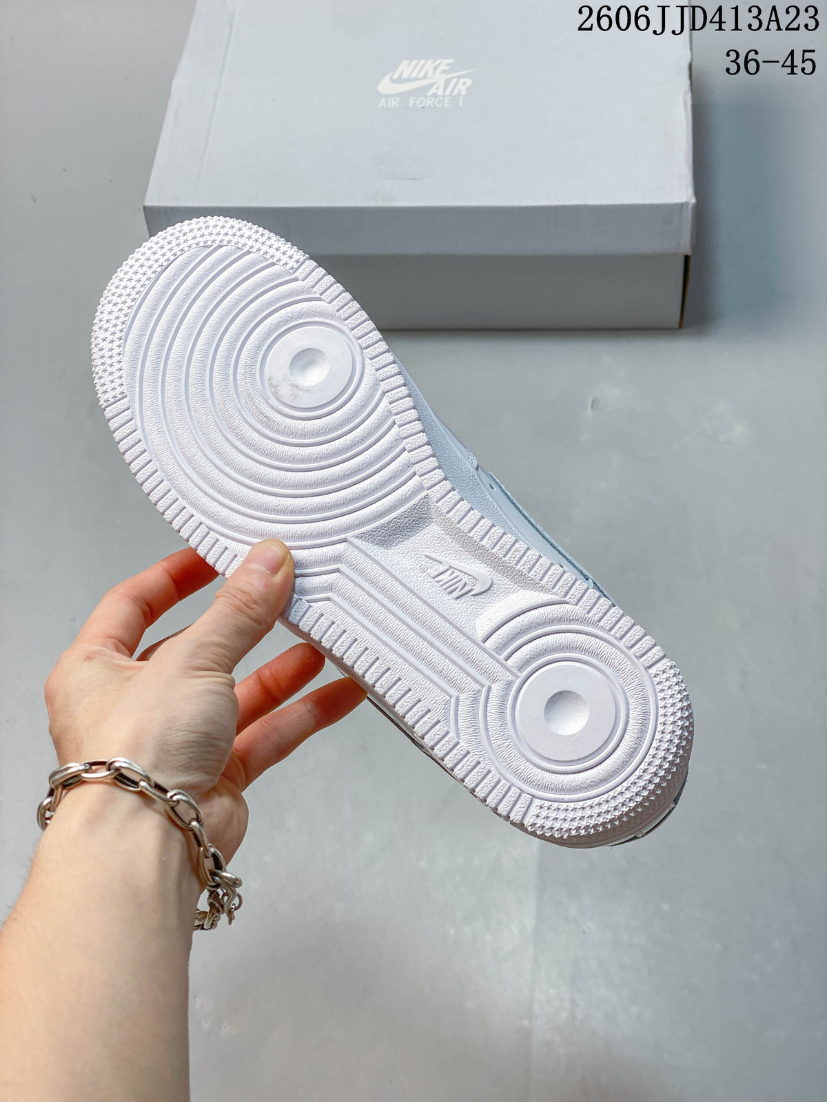 Close-up of the white sneaker outsole with circular traction patterns