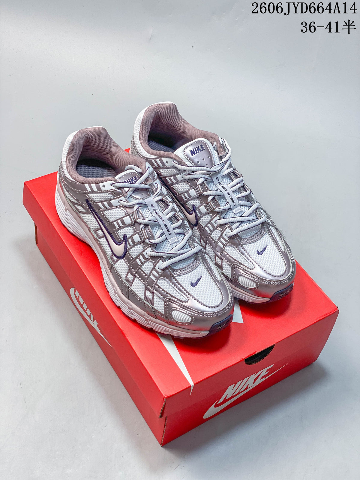 Pair of silver and purple Nike P-6000 sneakers displayed on a red shoe box