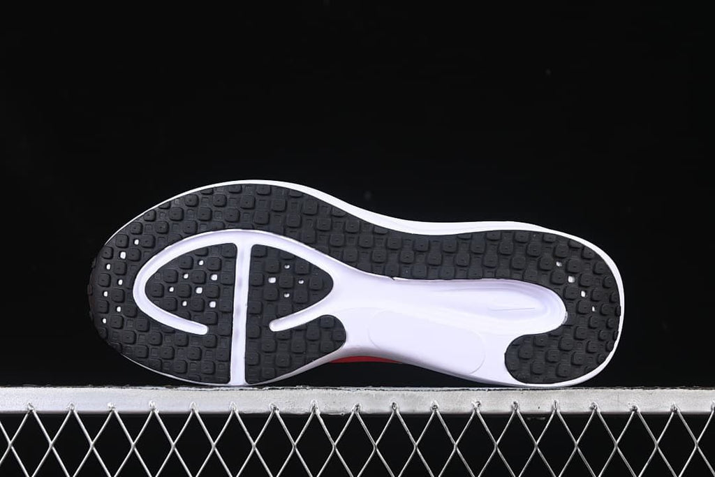 Underside view showing the black patterned outsole and white midfoot section
