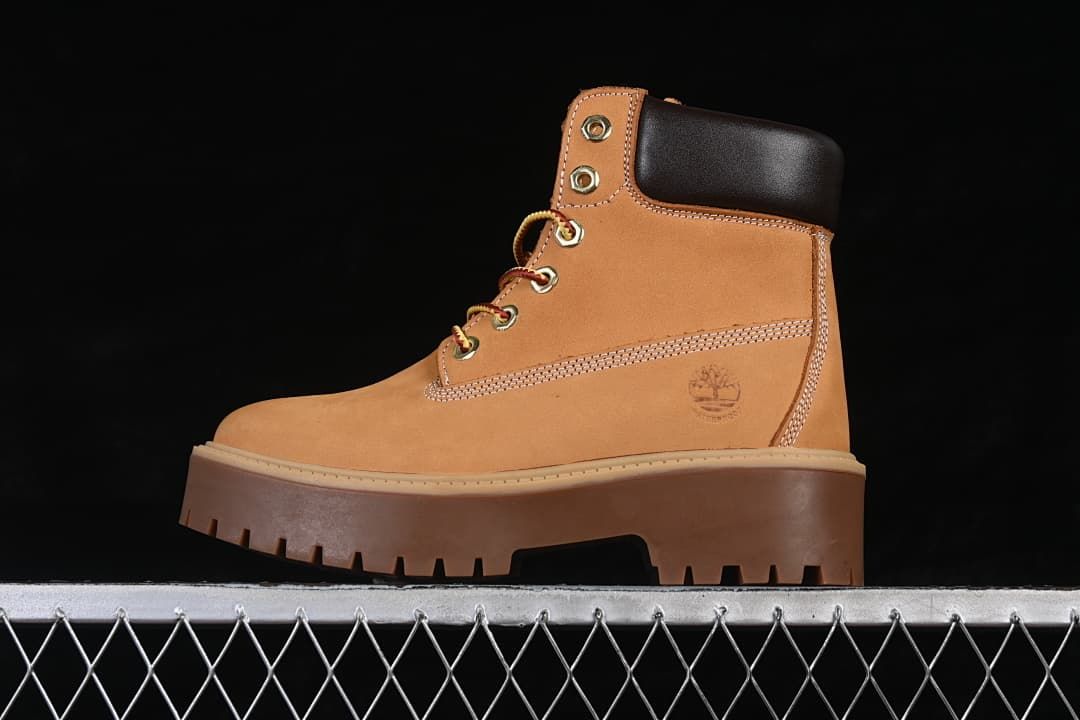 Side view of a wheat-colored Timberland lace-up boot with a dark padded collar and chunky platform sole