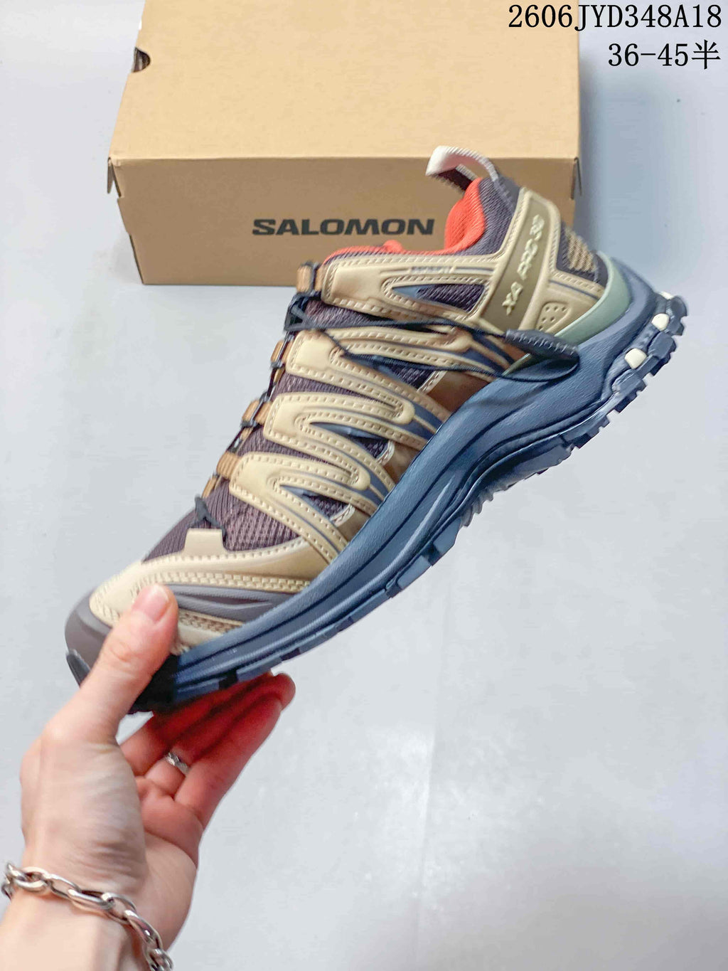 Side view of the taupe and beige Salomon XT-3D trail shoe; image also displays a size range.
