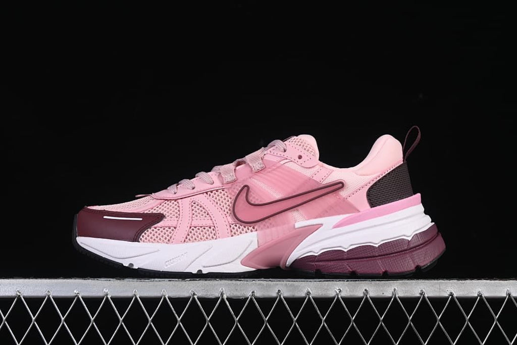 Side view of the pink Nike V2K Run sneaker