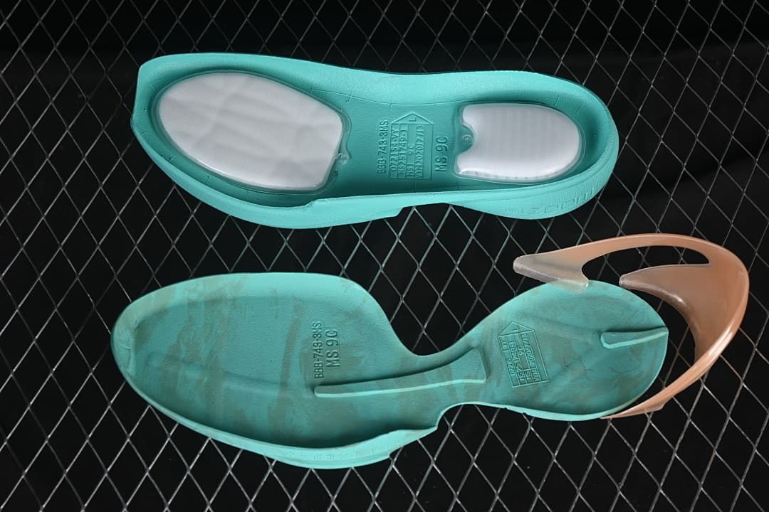 View of the shoe's turquoise outsole components and heel detail.