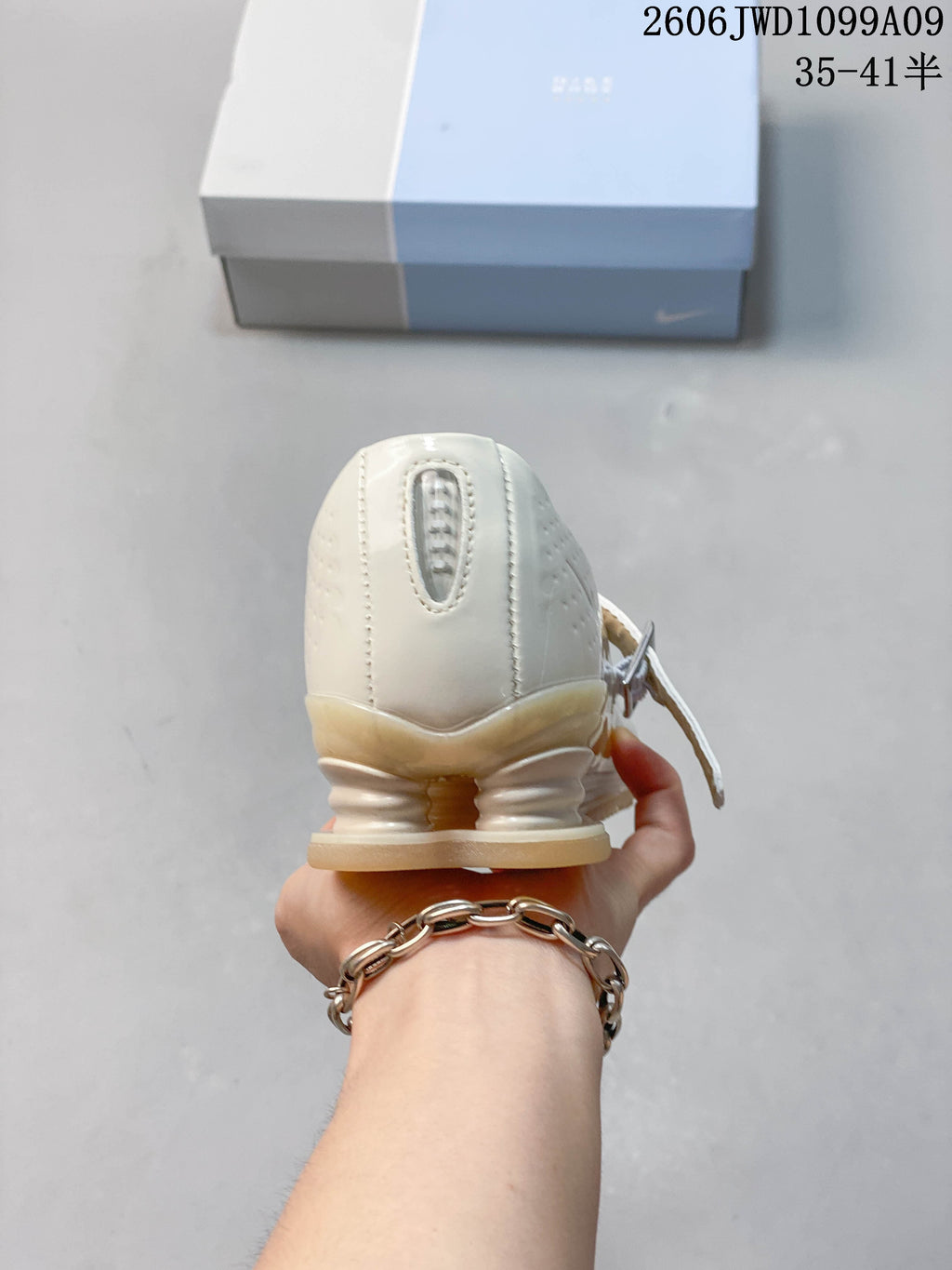 Rear view showing the sculpted heel detail on an ivory Mary Jane sneaker