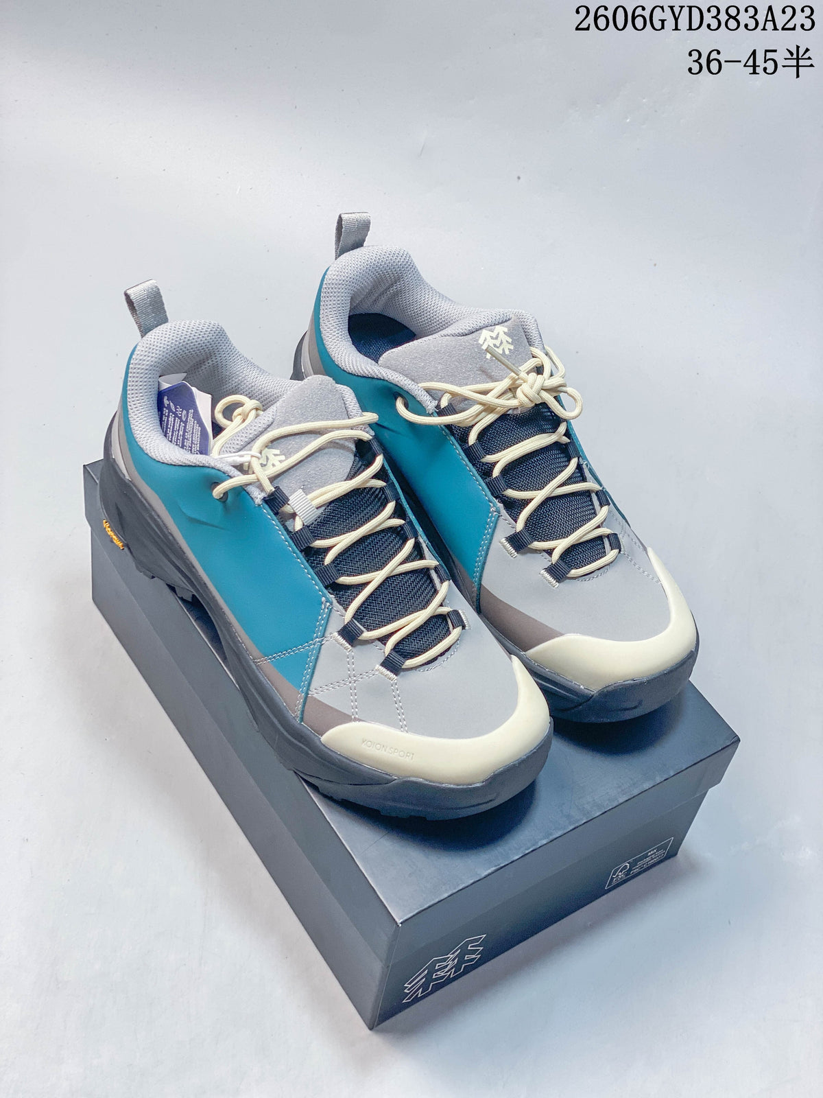 Pair of gray and turquoise Kolon Sport low-top outdoor shoes with cream accents