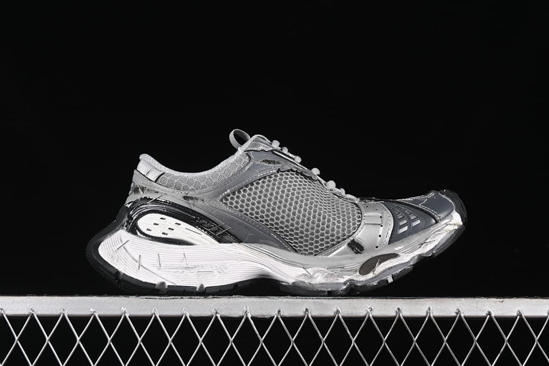 Side profile of the grey and silver sneaker with a chunky sculpted sole