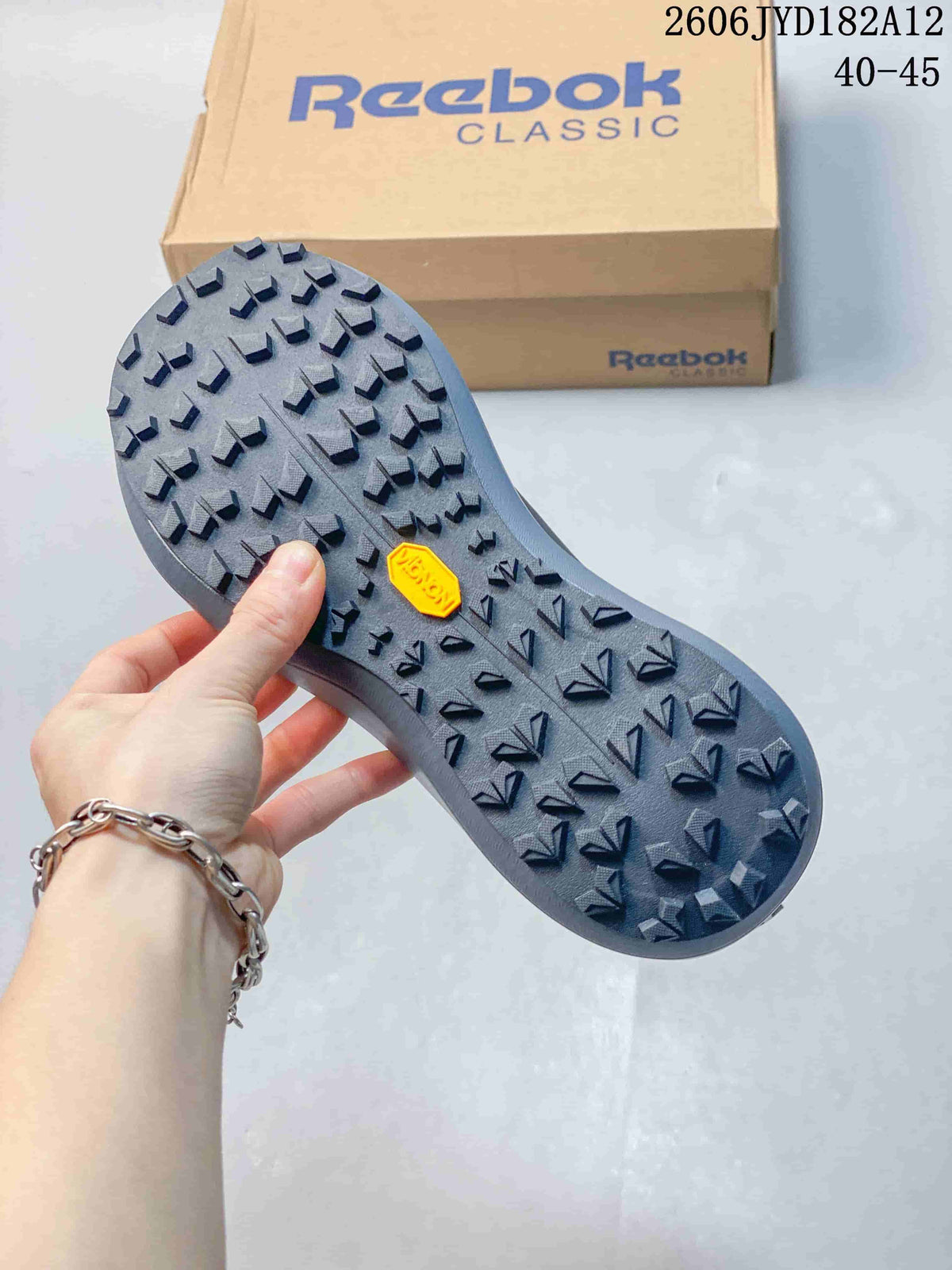 Close-up of the grey sneaker outsole with raised tread