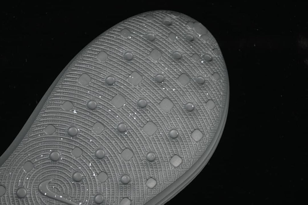 Close-up of the textured outsole on the grey clog sandal