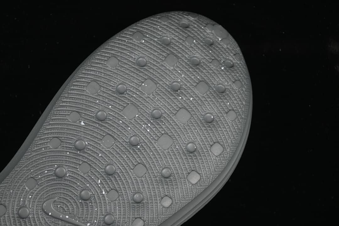 Close-up of the textured outsole on the grey clog sandal