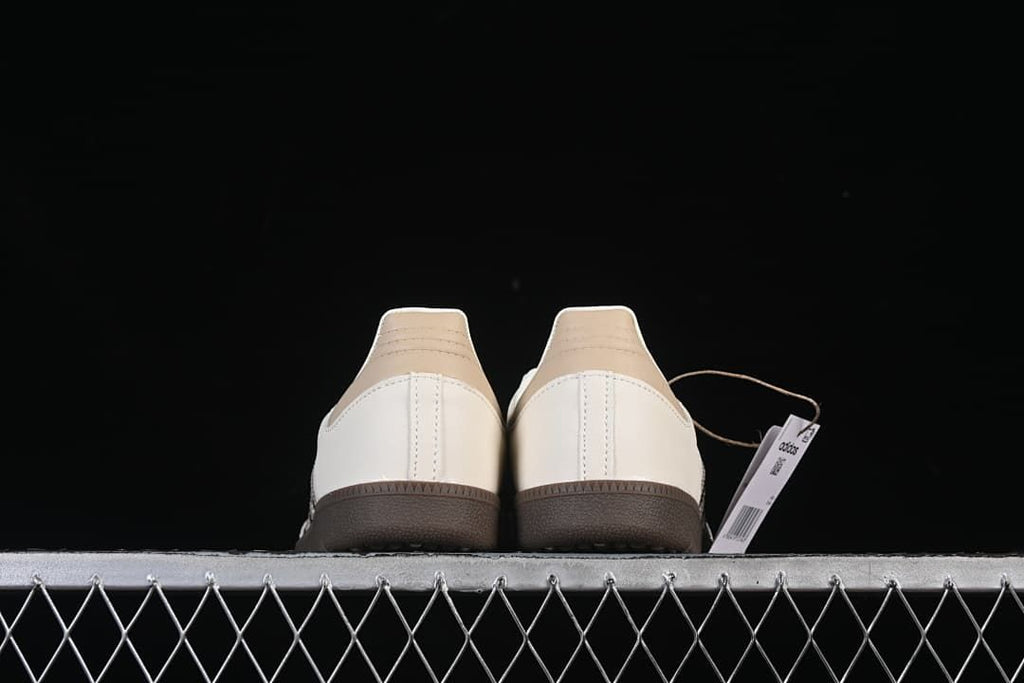 Rear view of both sneakers with beige heel panels and dark brown soles
