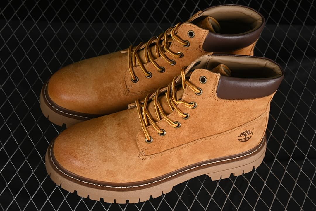 Pair of yellow-brown lace-up ankle boots shown at an angle