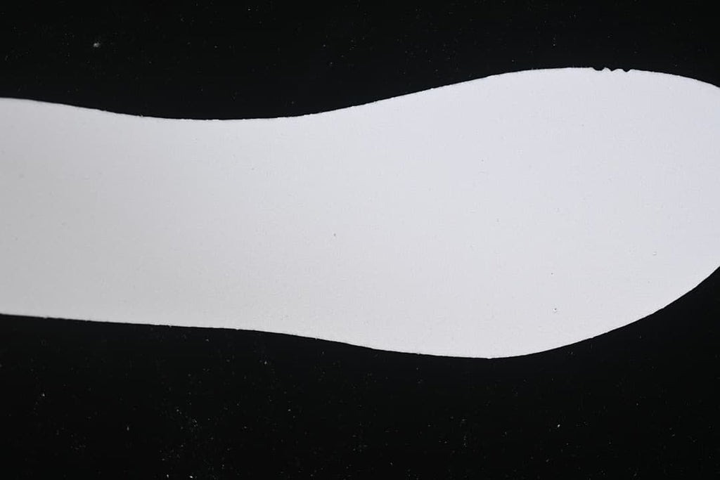 White shoe insole shown against a black background.
