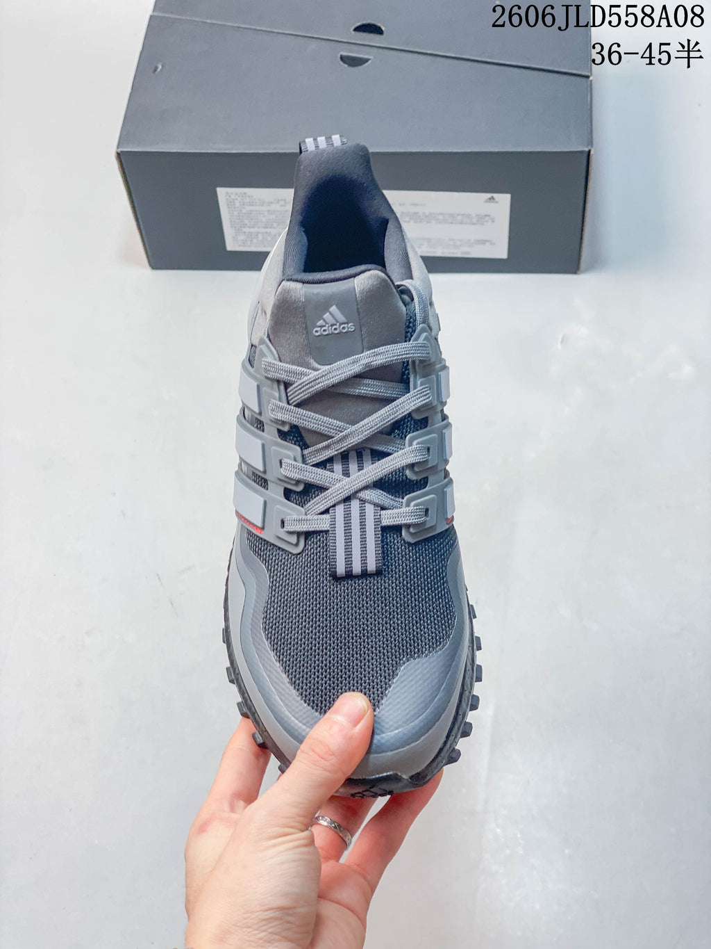 Front view highlighting the grey mesh-look upper, laces and structured side panels.