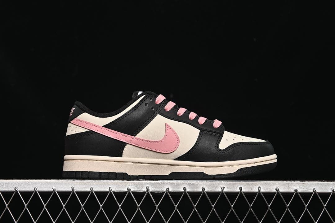 Side profile of a low-top sneaker with pink Swoosh and off-white midsole