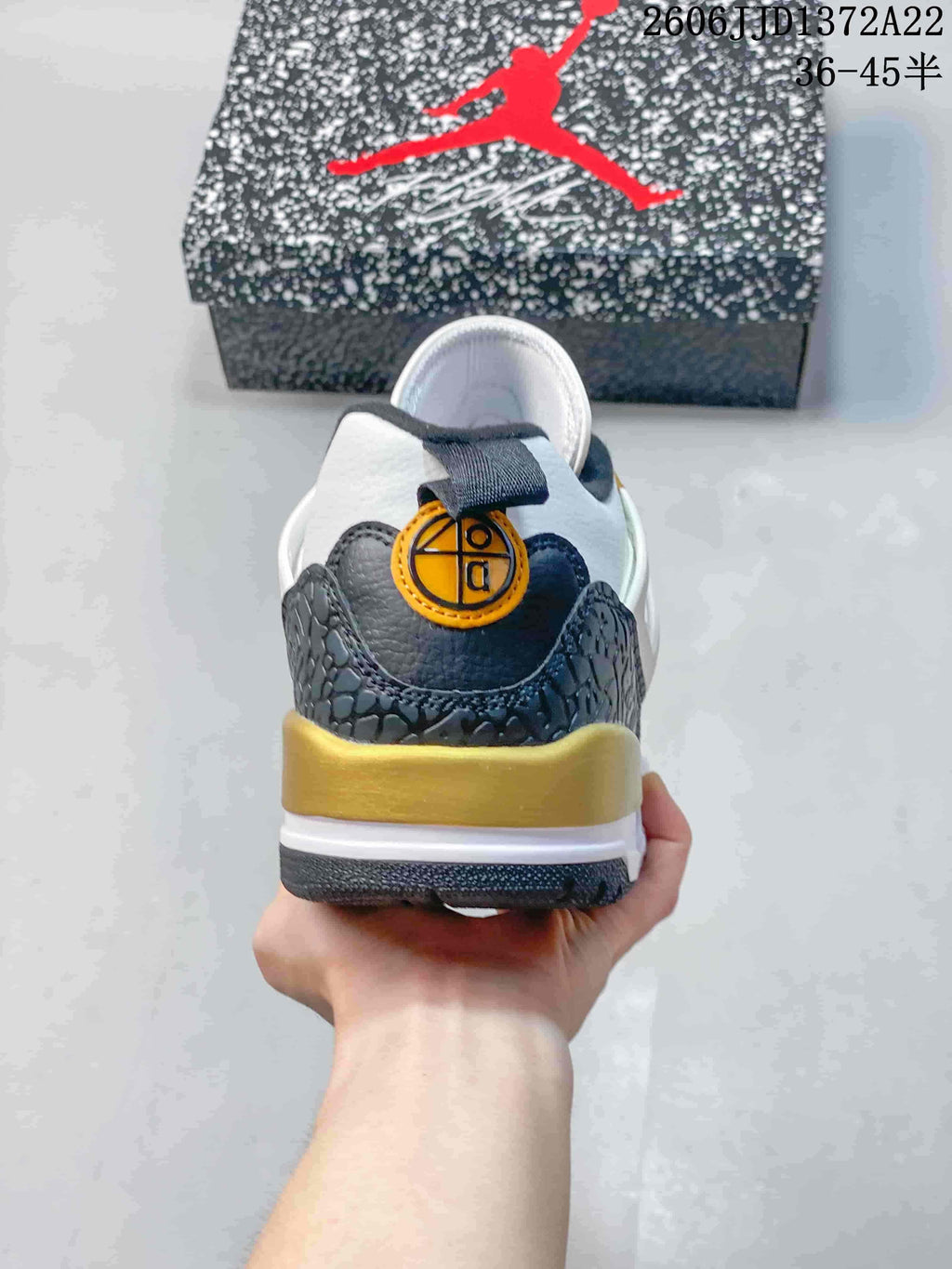 Rear view of the sneaker with navy and gold heel details