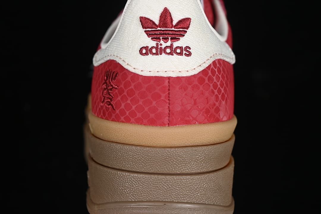 Rear close-up showing white heel tab, red branding and patterned red upper