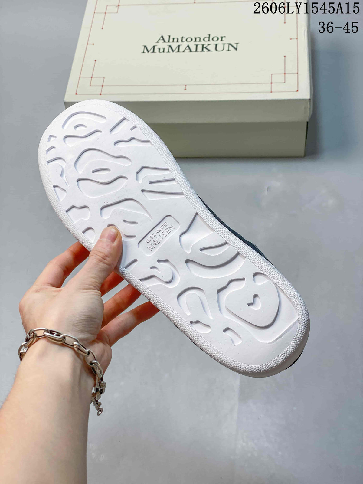 Underside of a white sneaker sole showing its molded tread pattern.
