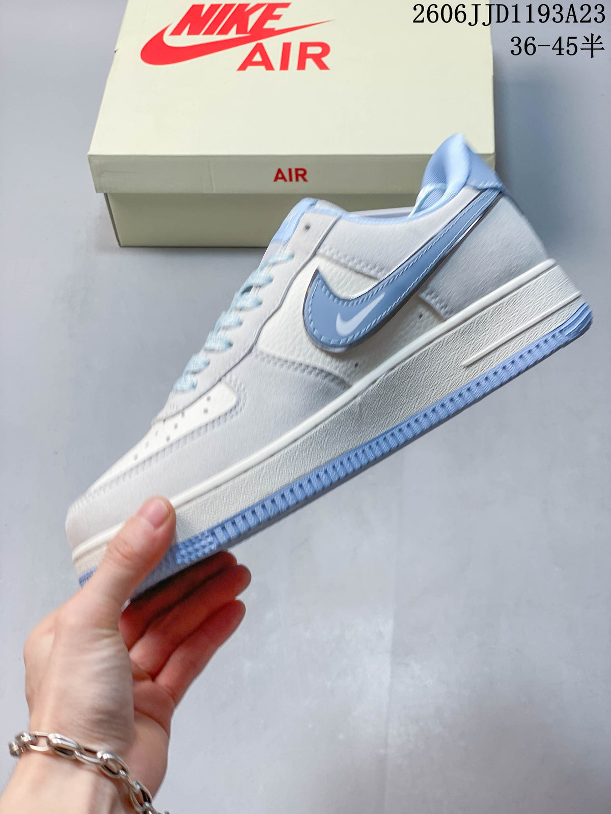 Side view of a white Nike Air Force 1 with a large pale blue Swoosh