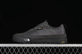Side view of charcoal grey The North Face low-top sneakers against a black background
