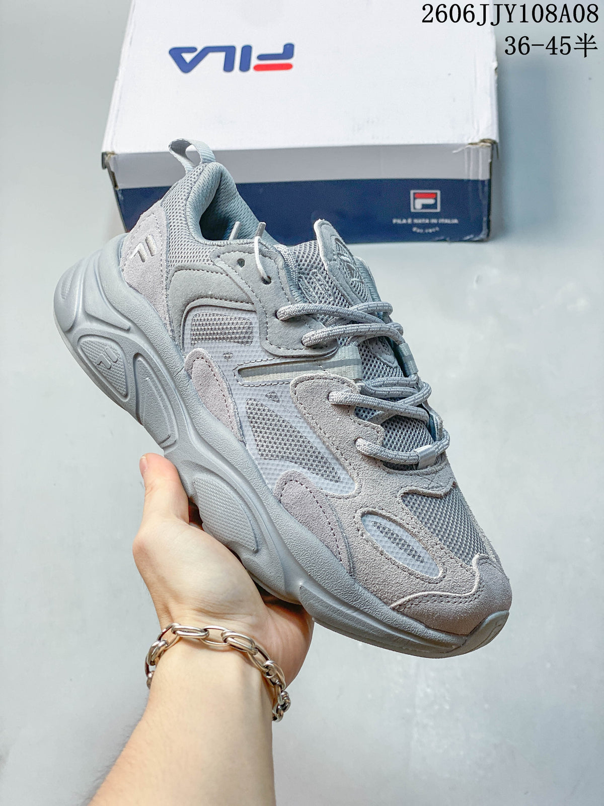 Light gray FILA Fusion sneaker with lace-up closure and chunky sculpted sole