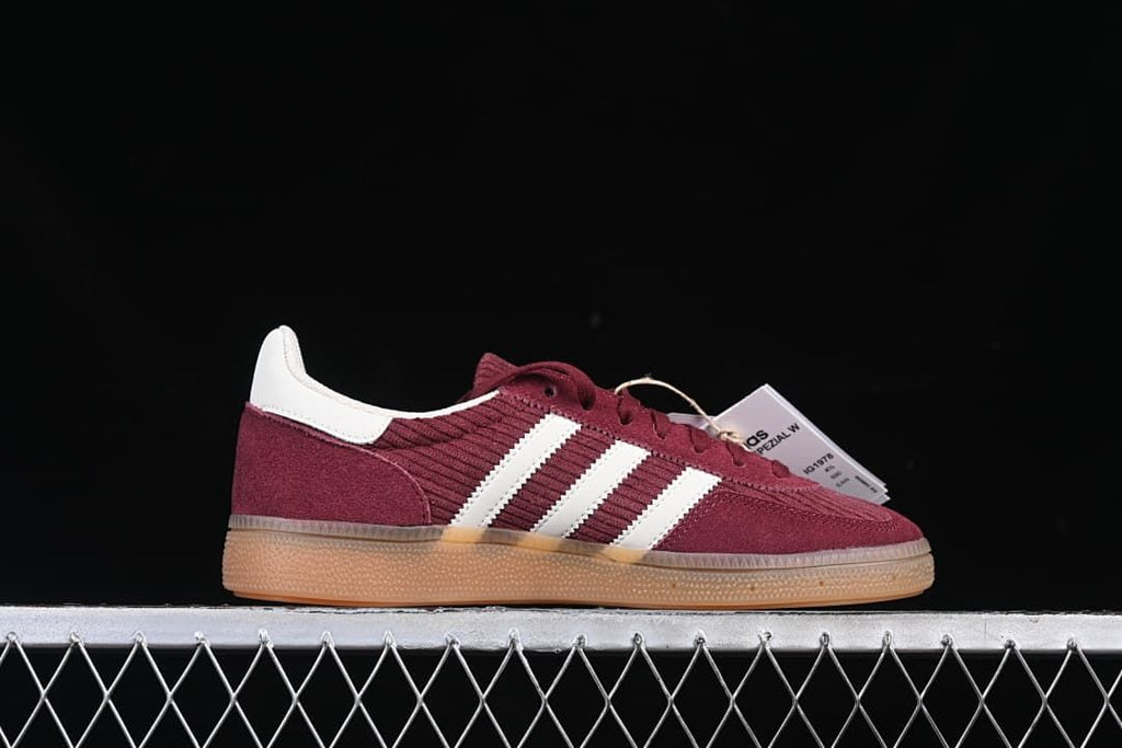 Side profile showing burgundy panels, white stripes, and gum-colored sole