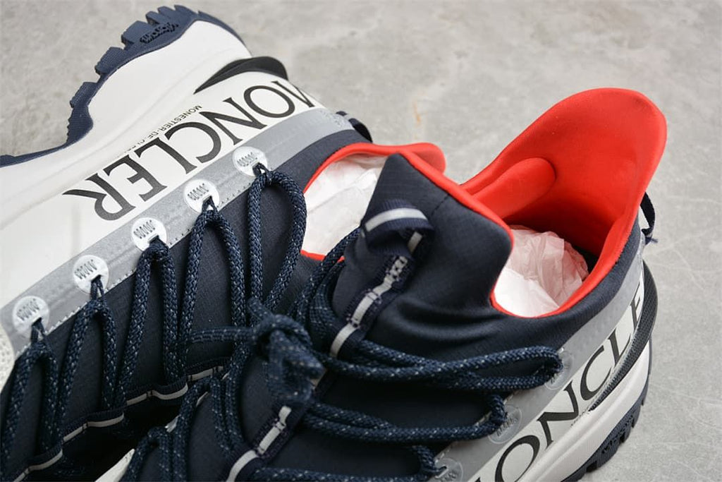 Close-up of the Trailgrip Lite2 collar, laces, and large side branding.
