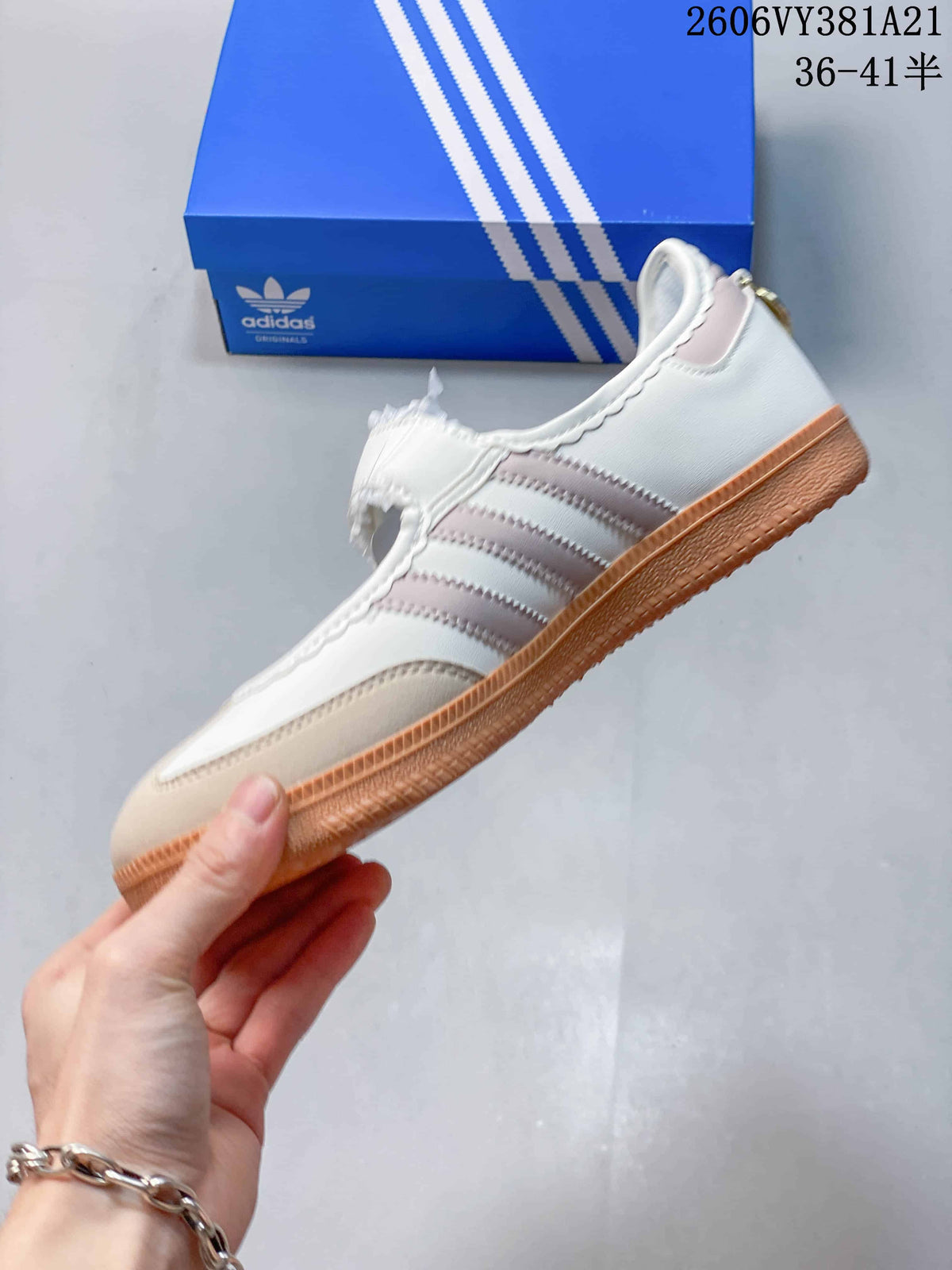 Side view of the sneaker with pale pink stripes and a gum-colored outsole