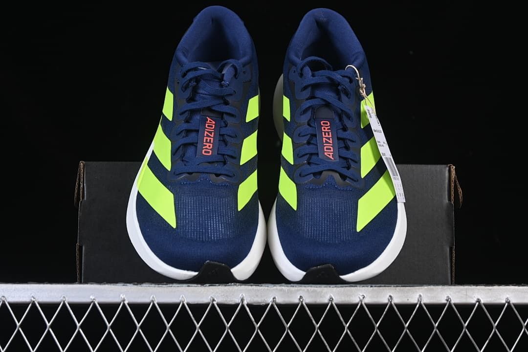 Front view of the pair showing navy uppers and lime accents.