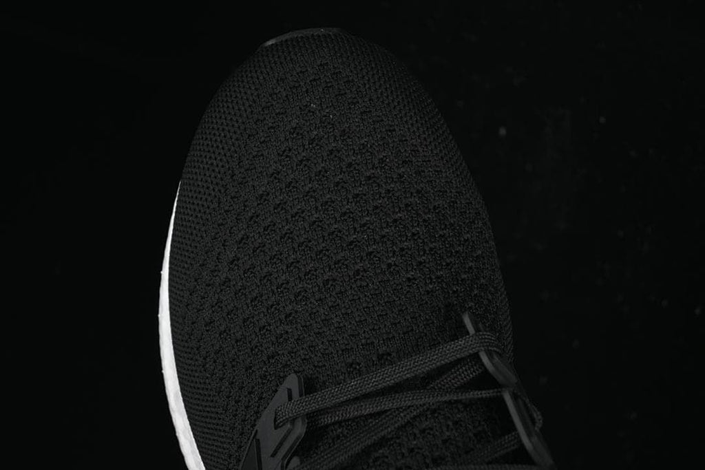 Top-down close-up of the knit toe and lace area.