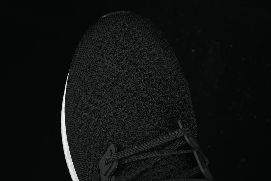 Top-down close-up of the knit toe and lace area.