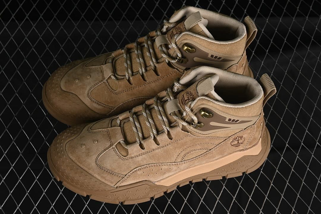 Pair of wheat-colored Timberland mid-top sneakers viewed from above.