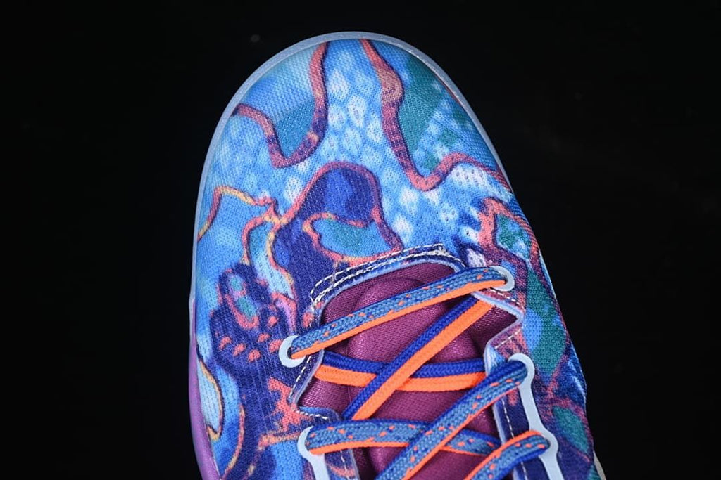 Top view of blue patterned toe and orange-and-blue laces