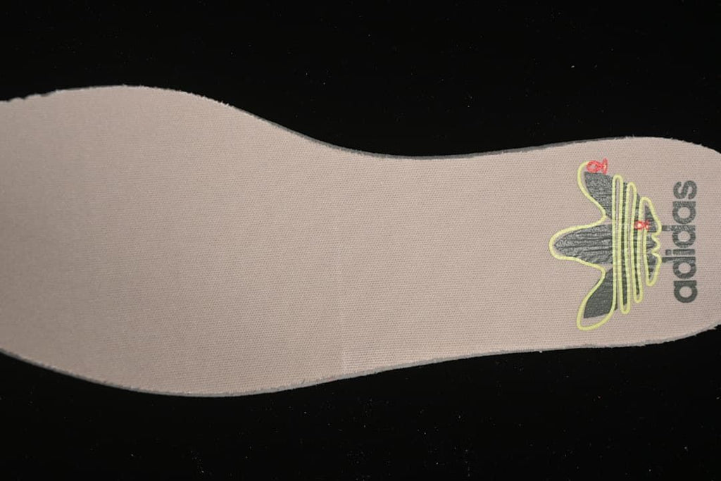 Close-up of the insole heel area with adidas branding.