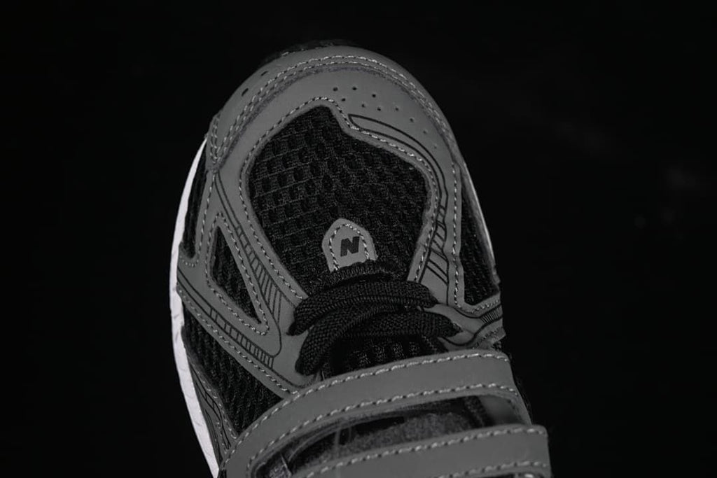 Top view of the sneaker toe, laces, mesh-like panels, and gray overlays.