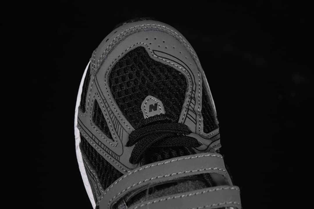 Top view of the sneaker toe, laces, mesh-like panels, and gray overlays.