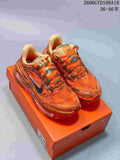 Pair of orange Nike Air Pegasus Premium sneakers displayed on an orange shoebox.