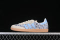Side view of adidas Samba OG JP8080 sneakers with a blue floral print, light blue stripes, cream overlays, and gum-colored sole
