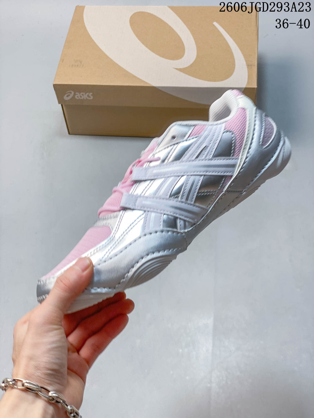 Side view showing the layered silver and white panels and pink details.