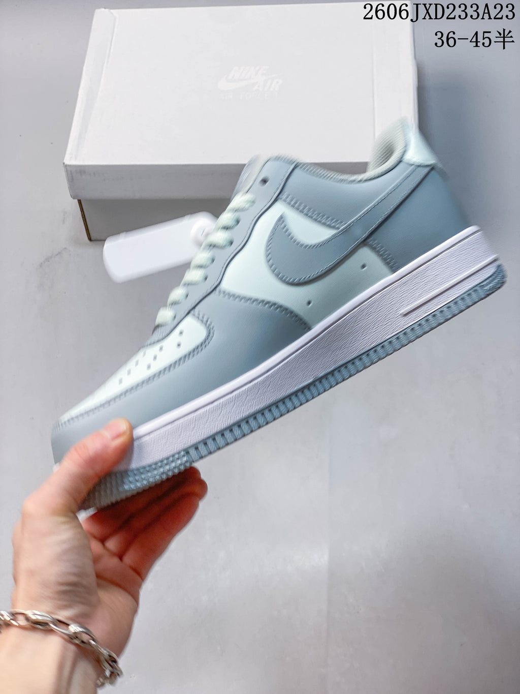 Side profile of a pale blue and white low-top sneaker