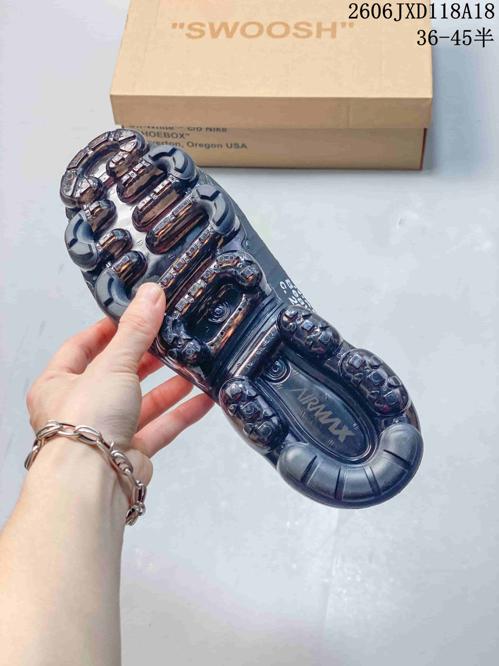 Underside of a Nike Air VaporMax sneaker showing a translucent segmented sole.