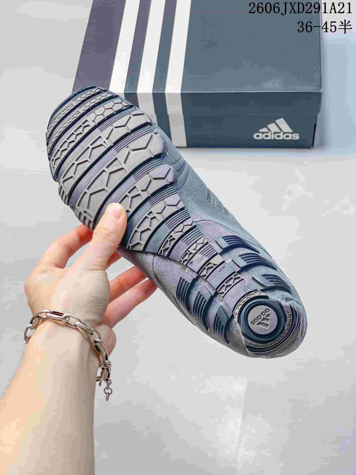 Close-up of the patterned outsole of a gray adidas Ghost Sprint sneaker.