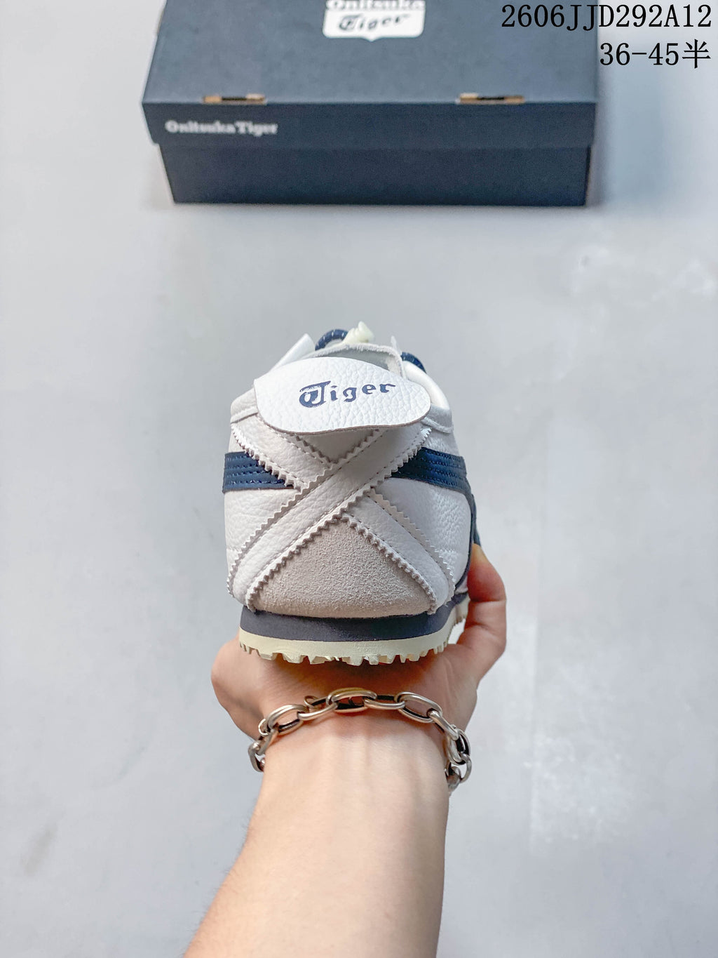 Rear view of the sneaker showing its crossed heel details and navy accent band.