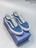 Pair of blue Vans Old Skool-style low-top sneakers with white side stripes and laces, displayed on a blue shoe box.