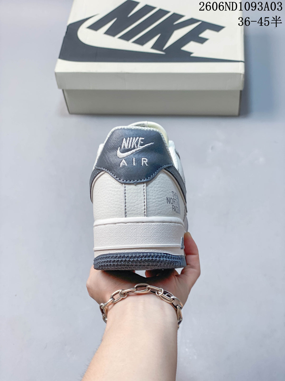 Rear view of the white and grey sneaker showing heel details and branding