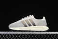 Side view of a grey and white adidas Retropy E5 sneaker with dark stripes and a cream midsole