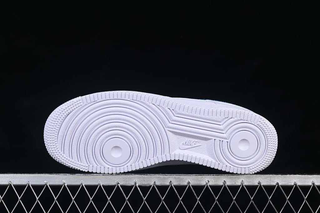 Underside of the white Nike Air Force 1 ’07 sneaker showing its circular tread pattern