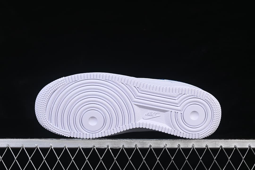 Underside of the white Nike Air Force 1 ’07 sneaker showing its circular tread pattern