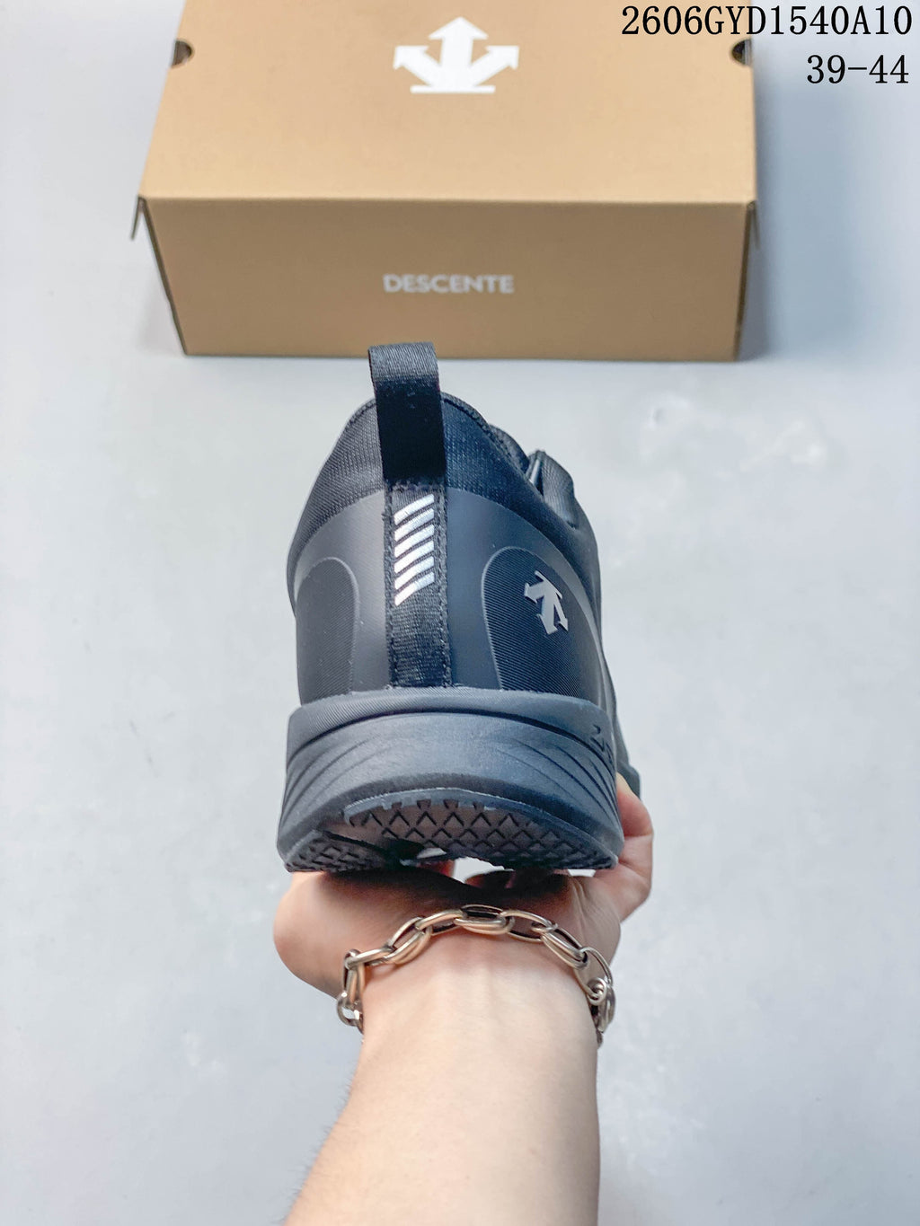 Rear view of the charcoal running shoe with heel pull tab and sculpted sole