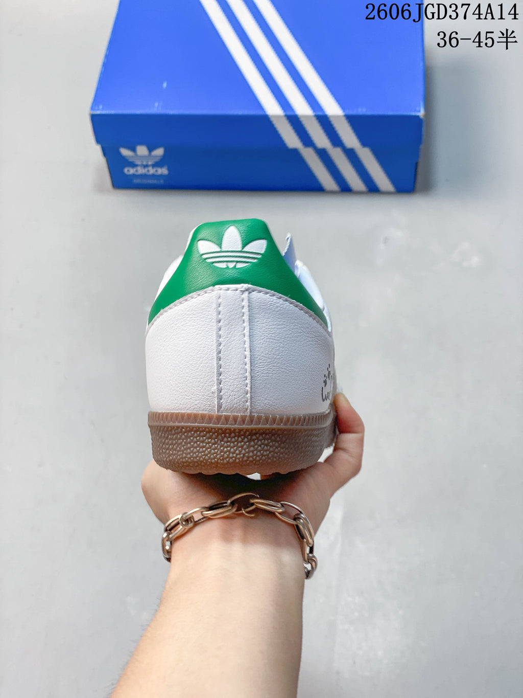 Rear view showing the white heel and green heel tab on a low-top sneaker.