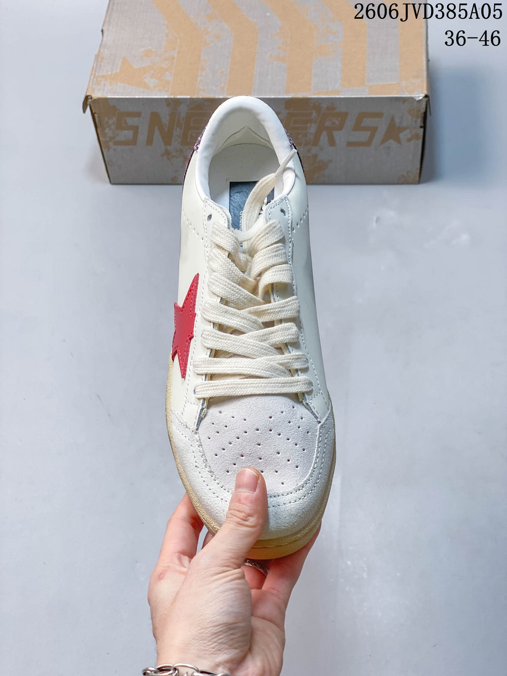 Front view of the sneaker showing the laces and perforated toe.